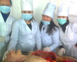 Asian medical students take photos with dismembered corpse